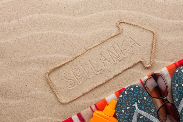 Sri Lanka  pointer and beach accessories lying on the sand — Stock Photo, Image