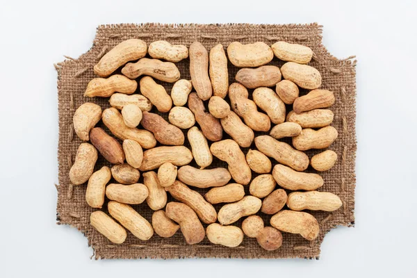 Figured frame made of burlap with peanut — Stock Photo, Image