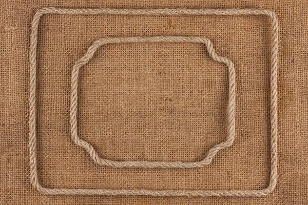 Two frame of rope, lies on a background of burlap — Stock Photo, Image