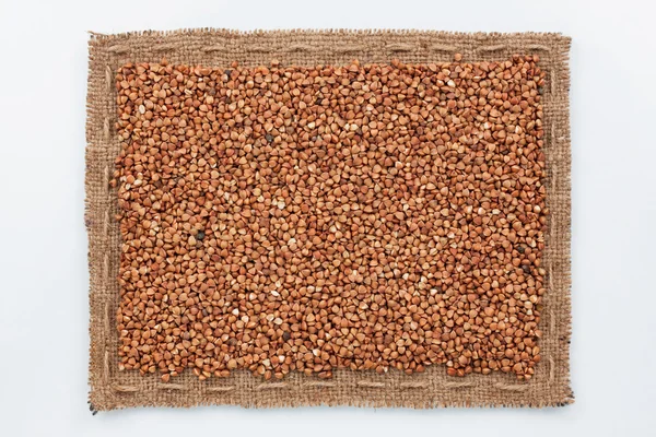 Frame of burlap and  buckwheat  grain — Stock Photo, Image