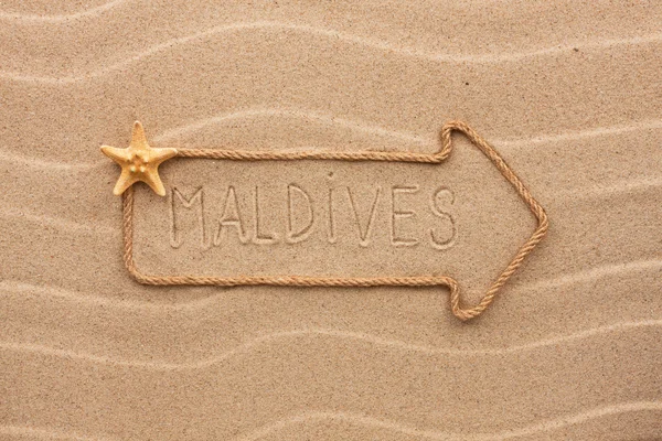 Arrow made of rope and sea shells with the word Maldives on the — Stock Photo, Image