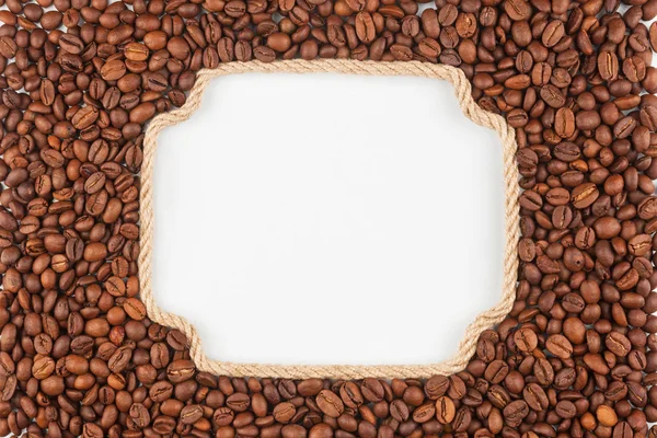 Figured frame  made of rope with  coffee beans  lying on a white — Stock Photo, Image