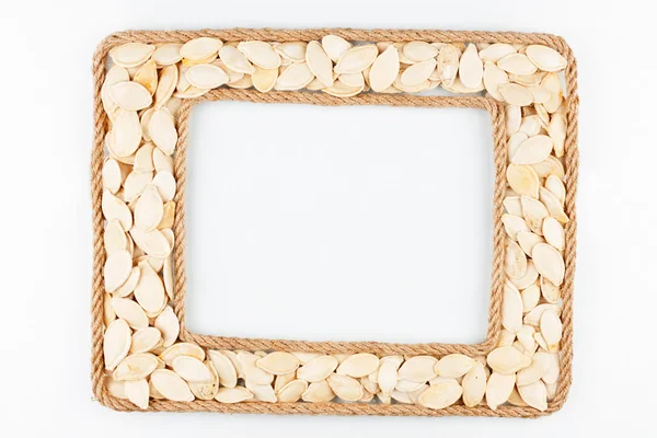 Two frames made of the rope with pumpkin seeds on a white backgr — Stock Photo, Image