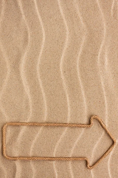 Pointer made of rope on the sand — Stock Photo, Image