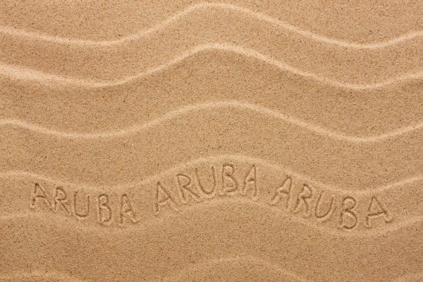 Aruba inscription on the wavy sand — Stock Photo, Image