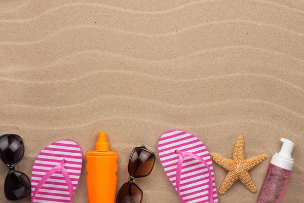 Accessories for the beach  lying on the sand — Stock Photo, Image