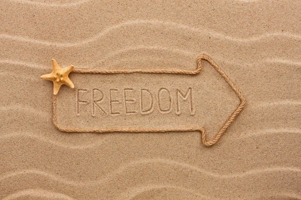 Pointer made of rope with an inscription  freedom, with starfish — Stock Photo, Image