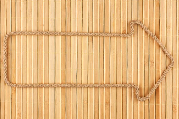 Arrow made of rope  lies on a bamboo mat — Stock Photo, Image