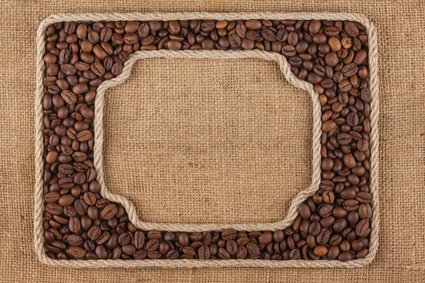 Dois quadros feitos de corda com grãos de café em pano de saco — Fotografia de Stock