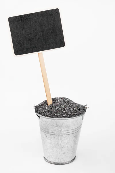 Pointer, price in bucket of  poppy seeds — Stock Photo, Image