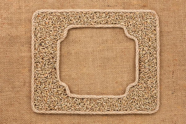 Two frames made of rope with rye  grains on sackcloth — Stock Photo, Image