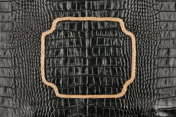 Figured frame made of rope lying on the crocodile  leather — Stock Photo, Image