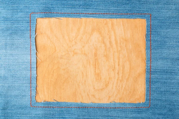 Frame for the text from a blue jeans fabric with the stitched lines of an orange thread — Stock Photo, Image