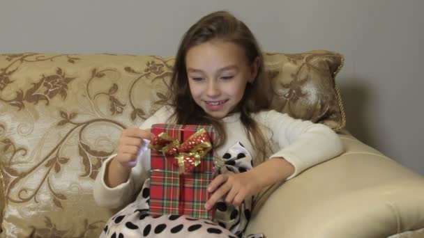 Cute little girl opens a gift box, surprise and joy — Stock Video