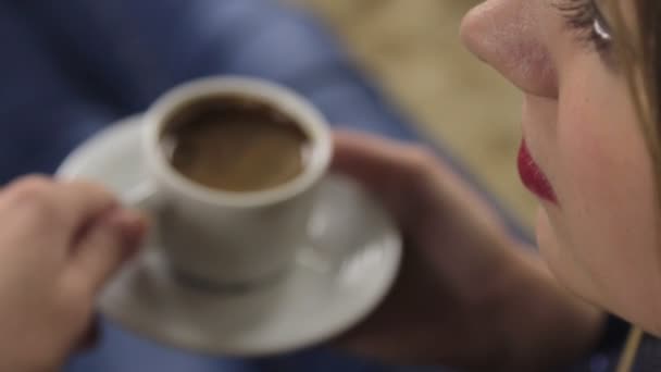 Attractive woman drinking coffee, sharpness between a person and a cup — Stock Video