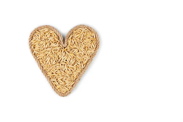 Symbolic heart made from rope with oats grains Royalty Free Stock Images