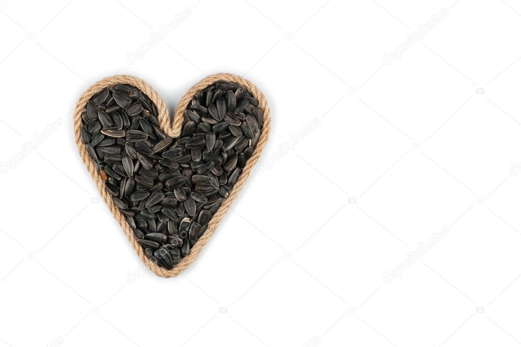 Symbolic heart made from rope with sunflower seeds 