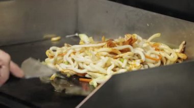 Lezzetli kızarmış erişte, taze sebzeler ve baharatlı soslar pişiriyorum.