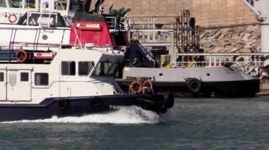 Gün ışığında deniz yaşamının dansını gösteren teknelerin yoğun limanda nasıl dolaştığını izleyin.