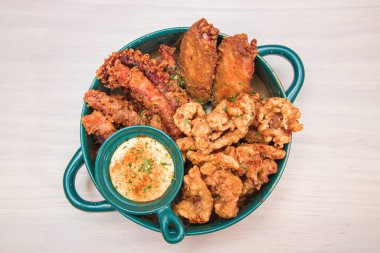 Susam sosuyla süslenmiş soğuk yosun salatasıyla dolu kahverengi bir seramik kase..