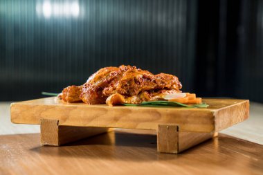 Baharatlı terbiye edilmiş domuz dilimleri ahşap bir tahtada garnitürle hazırlanmış, ızgara ya da pişirmeye hazır..