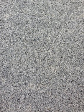 Pürüzsüz gri taş bir yüzeye yakın çekim..