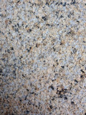 Doğal benekli deseni ve pürüzlü dokuyu gösteren granit yüzeyin ayrıntılı görüntüsü.