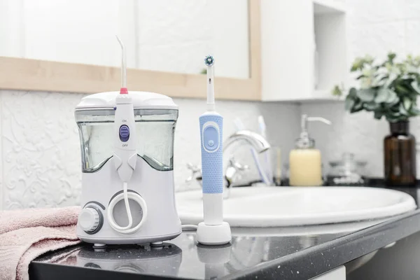 Electric Oral Irrigator Rechargeable Toothbrush White Tiled Bathroom Closeup — Stock Photo, Image