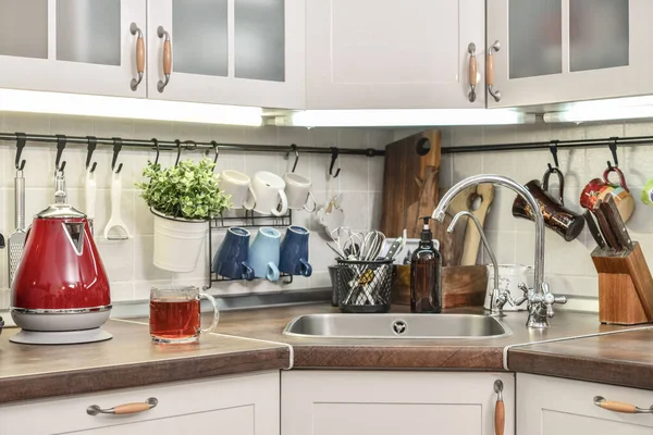 Red electric kettle in retro slile  in kitchen interior closeup