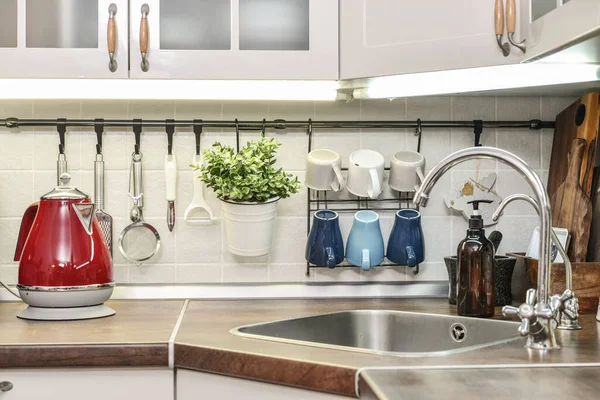 Red electric kettle in retro slile  in kitchen interior closeup