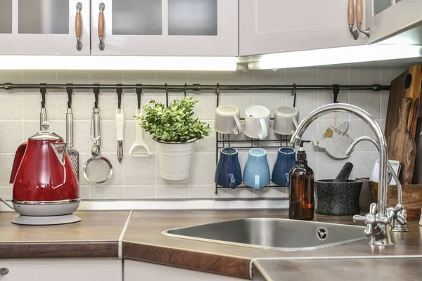 Red electric kettle in retro slile  in kitchen interior closeup