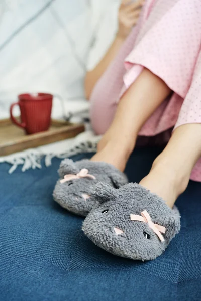 Female legs in cute slippers — Stock Photo, Image