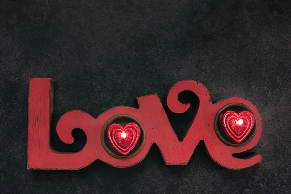 Word Love, with two small red candle, top view — Stock Photo, Image