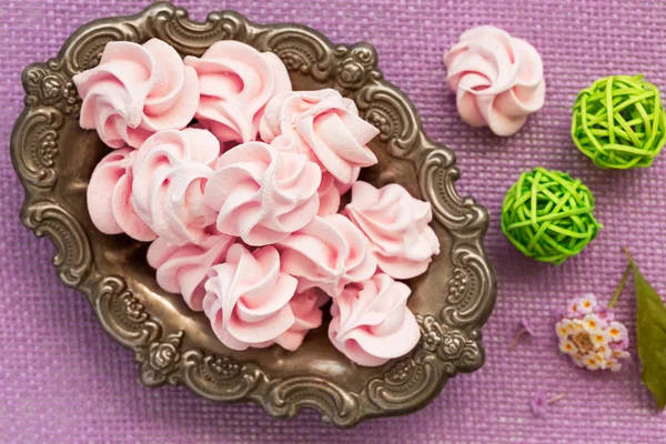 Pink meringue on antic plate, top view — Stock Photo, Image