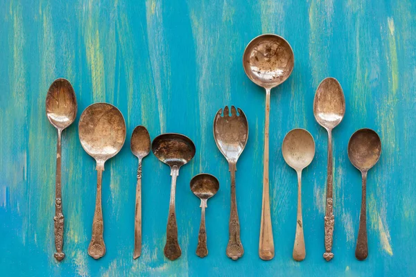 Old cutlery an blue wooden background, top view — Stock Photo, Image