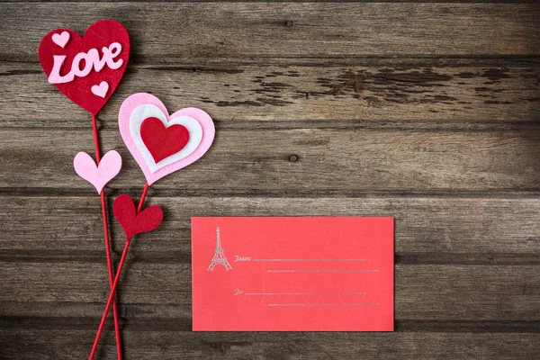Red envelope and valentine decoration with word LOVE on old wood — Stock Photo, Image