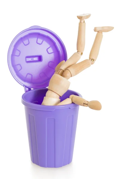 Wooden mannequin doll upside down in purple dustbin, isolated — Stock Photo, Image