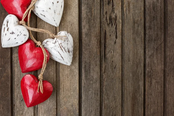 Red wooden hearts on old brown wooden background — Stock Photo, Image