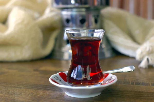 Traditional Turkish tea in original glass on wooden background.