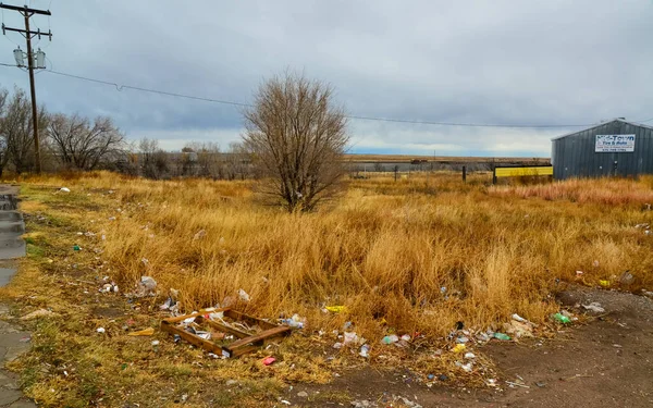 Trash on the side of a road near a desert settlement in New Mexico, USA