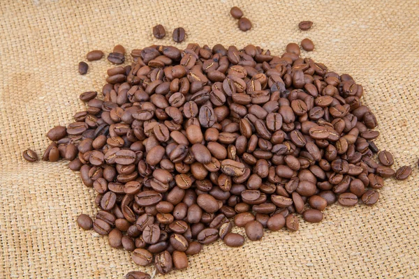 Coffee beans on burlap — Stock Photo, Image