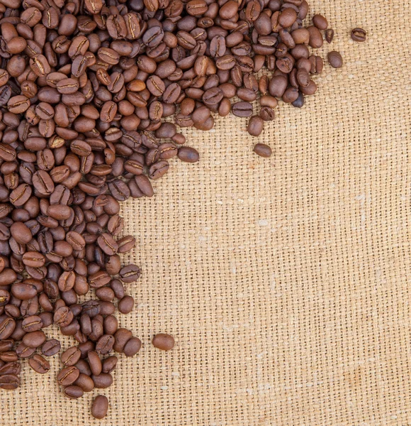 Coffee beans corner on burlap — Stock Photo, Image