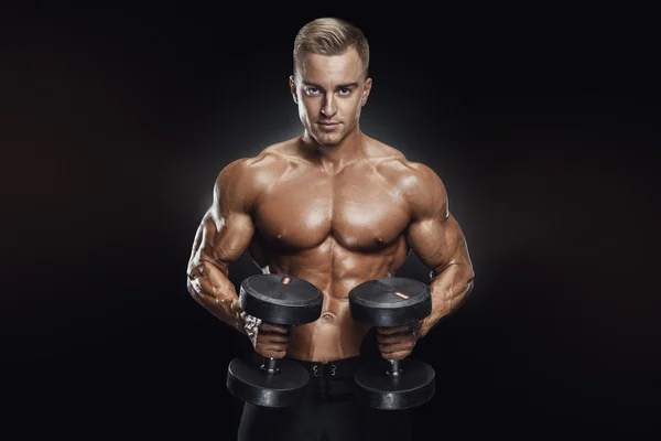 Handsome athletic guy workout with dumbbells — Stock Photo, Image