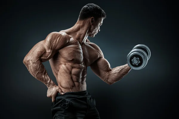 Strong and power bodybuilder doing exercises with dumbbell — Stock Photo, Image