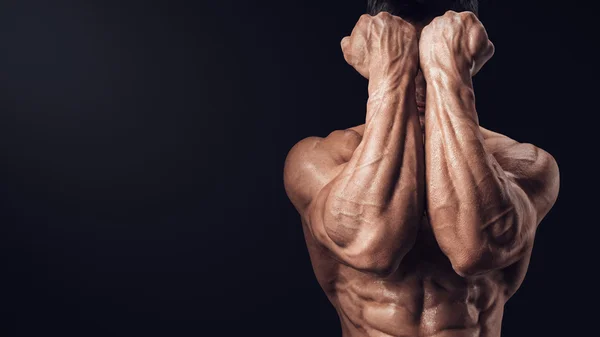 Close-up of a man's fists and abs. — Stock Photo, Image