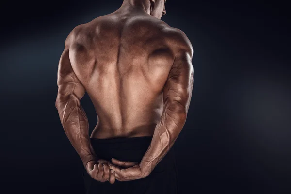 Handsome power bodybuilder showing his back — Stock Photo, Image