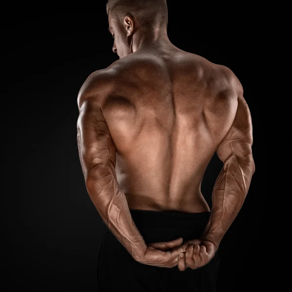 Handsome power bodybuilder showing his back — Stock Photo, Image