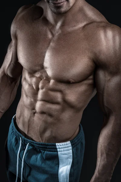 Strong athletic man fitness model showing torso muscles — Stock Photo, Image