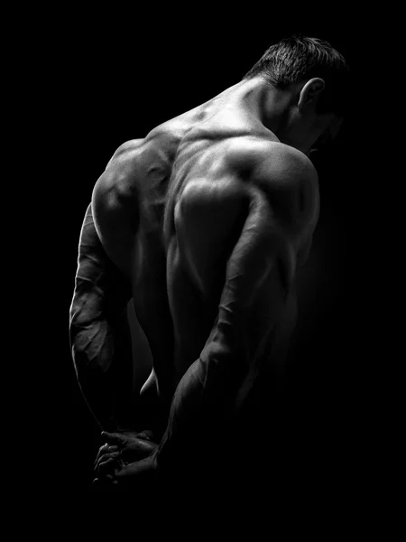 Handsome muscular bodybuilder turned back — Stock Photo, Image
