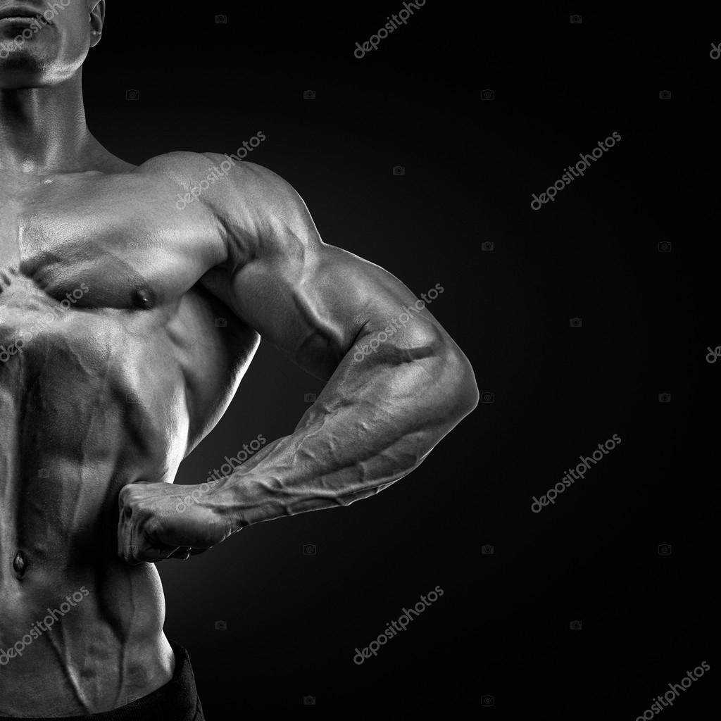 Handsome muscular bodybuilder posing on Front Lat Spread Stock Photo by ...